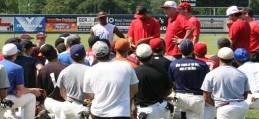 UHV Jaguars baseball coach Terry Puhl talks with a group of prospects Thursday at Riverside Stadium.