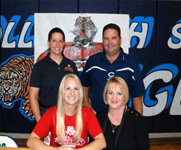 Ashley Winegeart of Mary Carroll High School in Corpus Christi, lower left, signs a letter of intent to play softball at UHV.